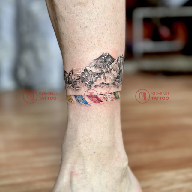 mountain and prayer flags tattoo in nepal, travel tattoo by suminu tattoo