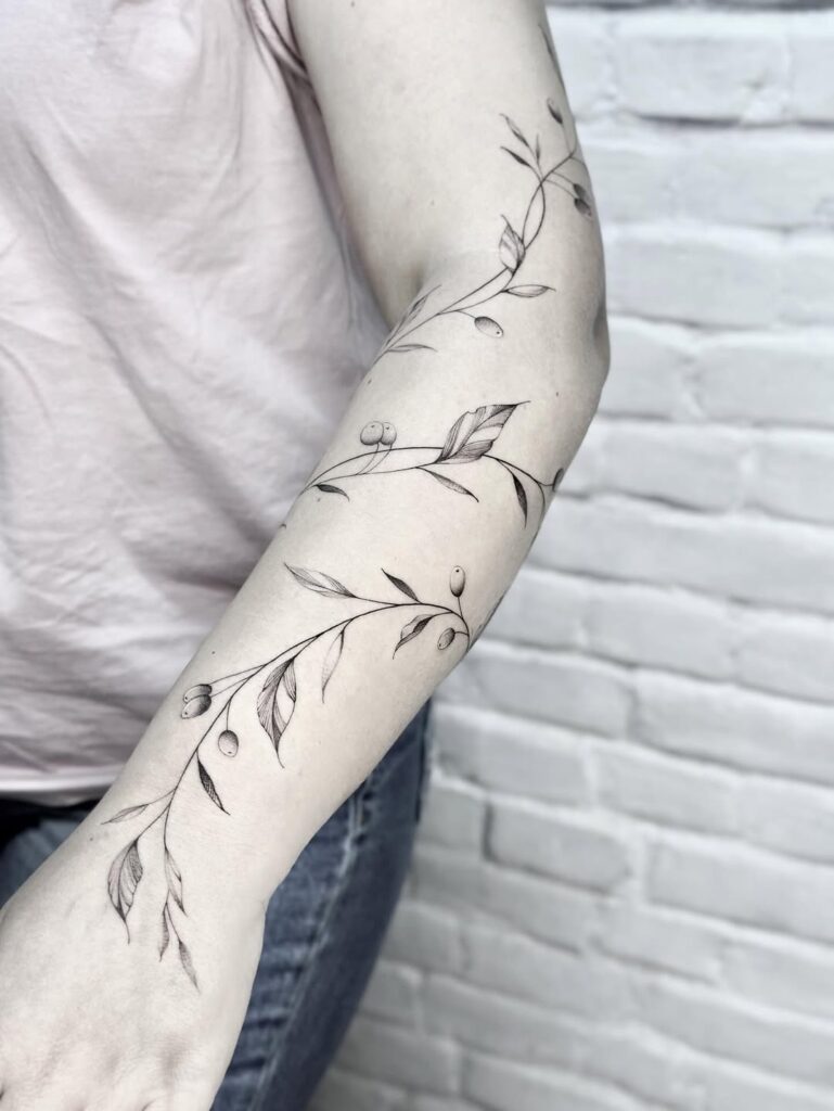 fine line flowers and vines tattoo in arm